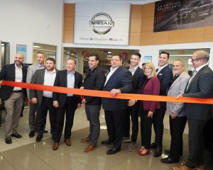 Nissan Regional VP Arcangelo Lofaro cuts the second ribbon with Nissan Representatives, Isaac Weiner, Jeffrey Weiner, Michael Ianelli, Nick Ianelli, Mike Ianelli Jr., Rich Willis GM