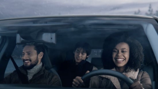 Three passengers riding in a vehicle and smiling | Nissan City of Red Bank in Red Bank NJ