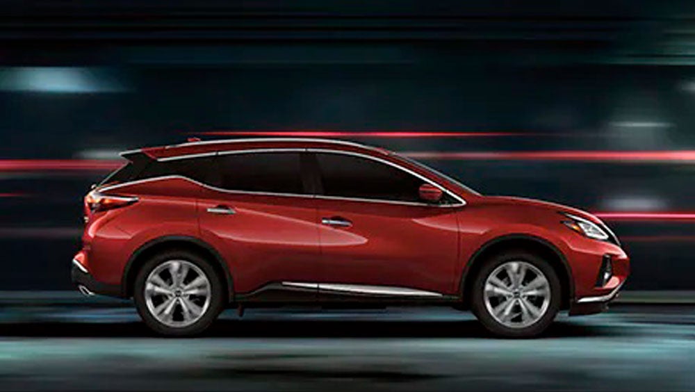 2023 Nissan Murano shown in profile driving down a street at night illustrating performance. | Nissan City of Red Bank in Red Bank NJ